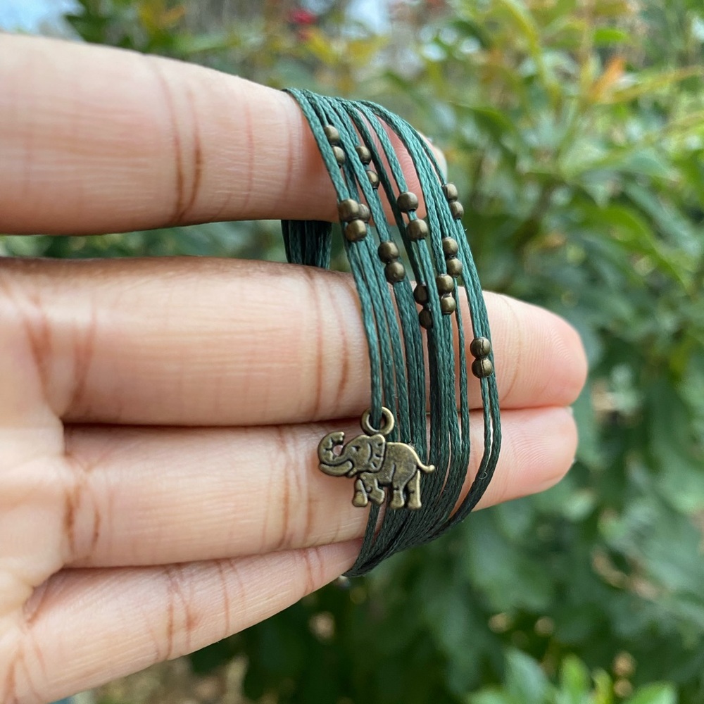Green handmade macrame bracelet with elephant charm